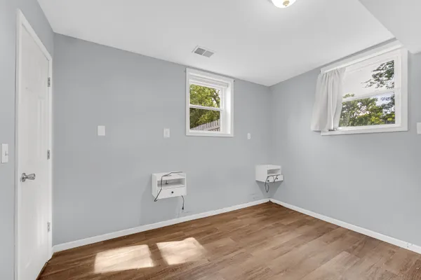 a view of room with window and hardwood floor