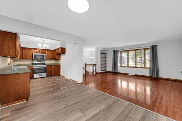 a view of kitchen with wooden floor and electronic appliances
