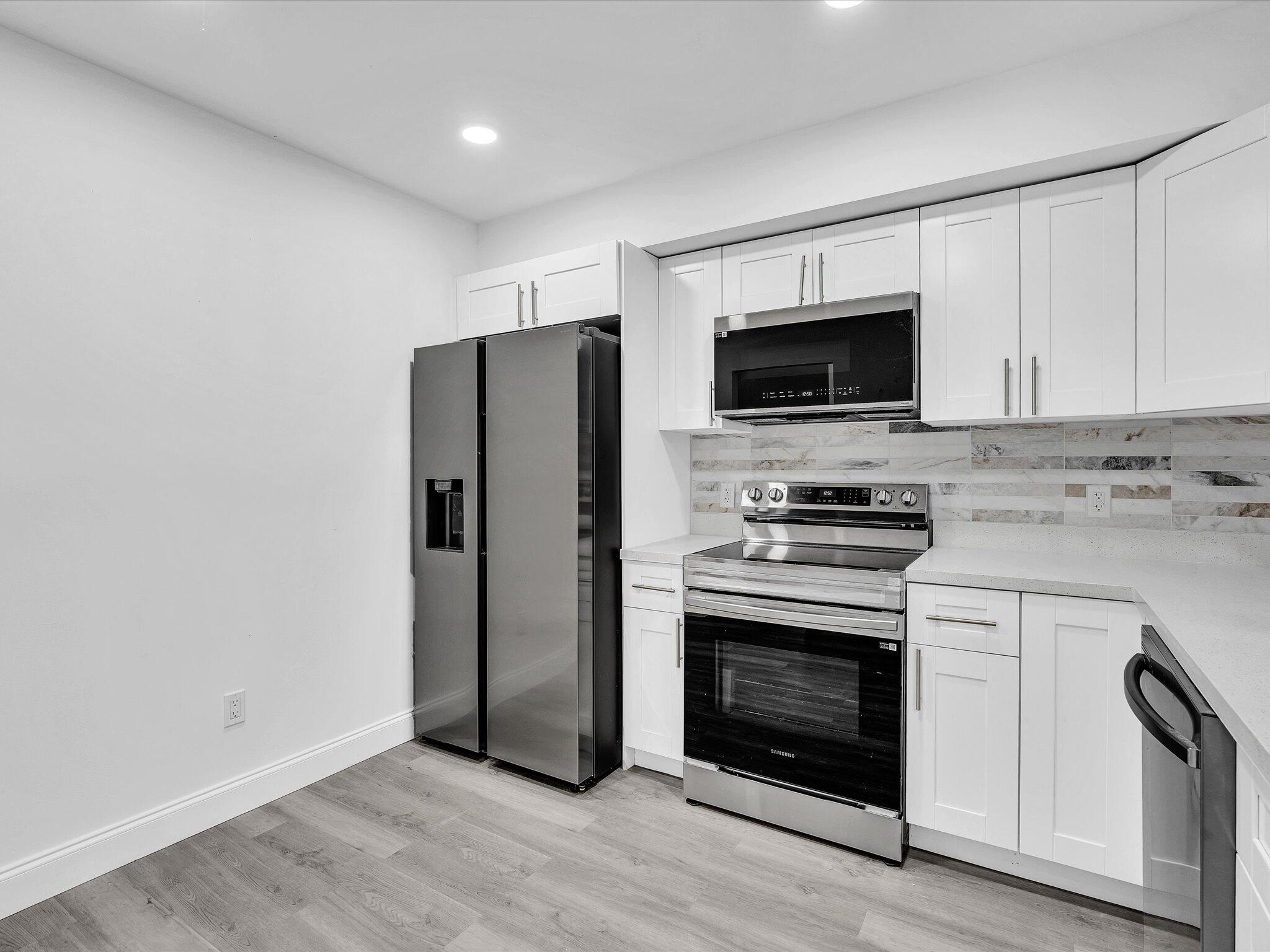 3841 Farragut Street Hollywood, FL 33021 - Photo 11 of 47 a kitchen with a stove microwave and refrigerator