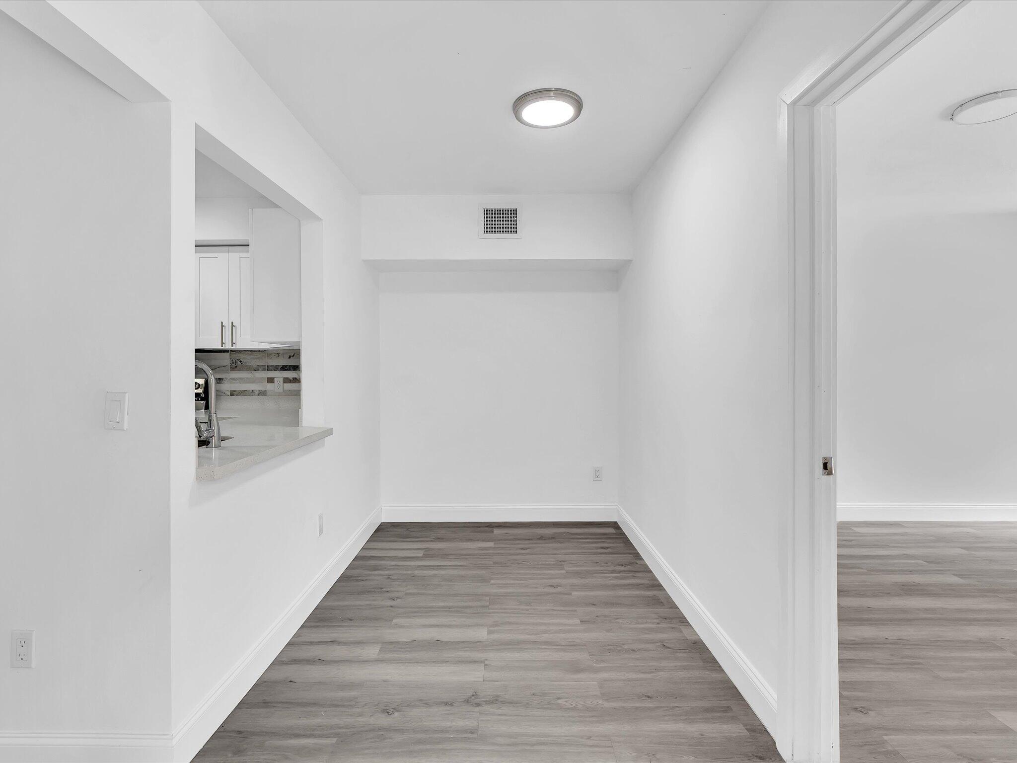 3841 Farragut Street Hollywood, FL 33021 - Photo 14 of 47 a view of a hallway with wooden floor and staircase