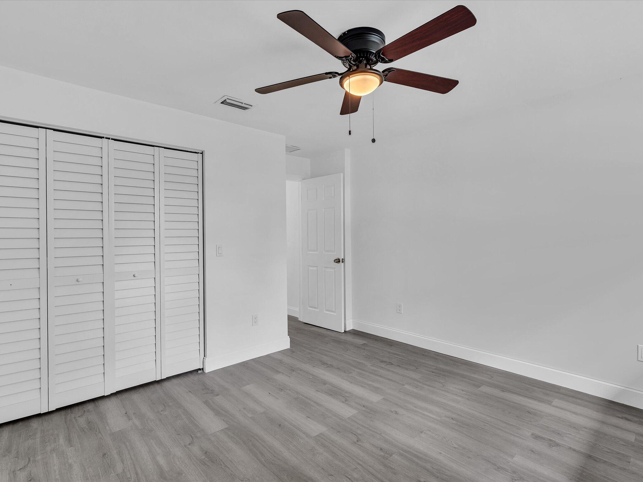 3841 Farragut Street Hollywood, FL 33021 - Photo 29 of 47 an empty room with wooden floor closet and fan