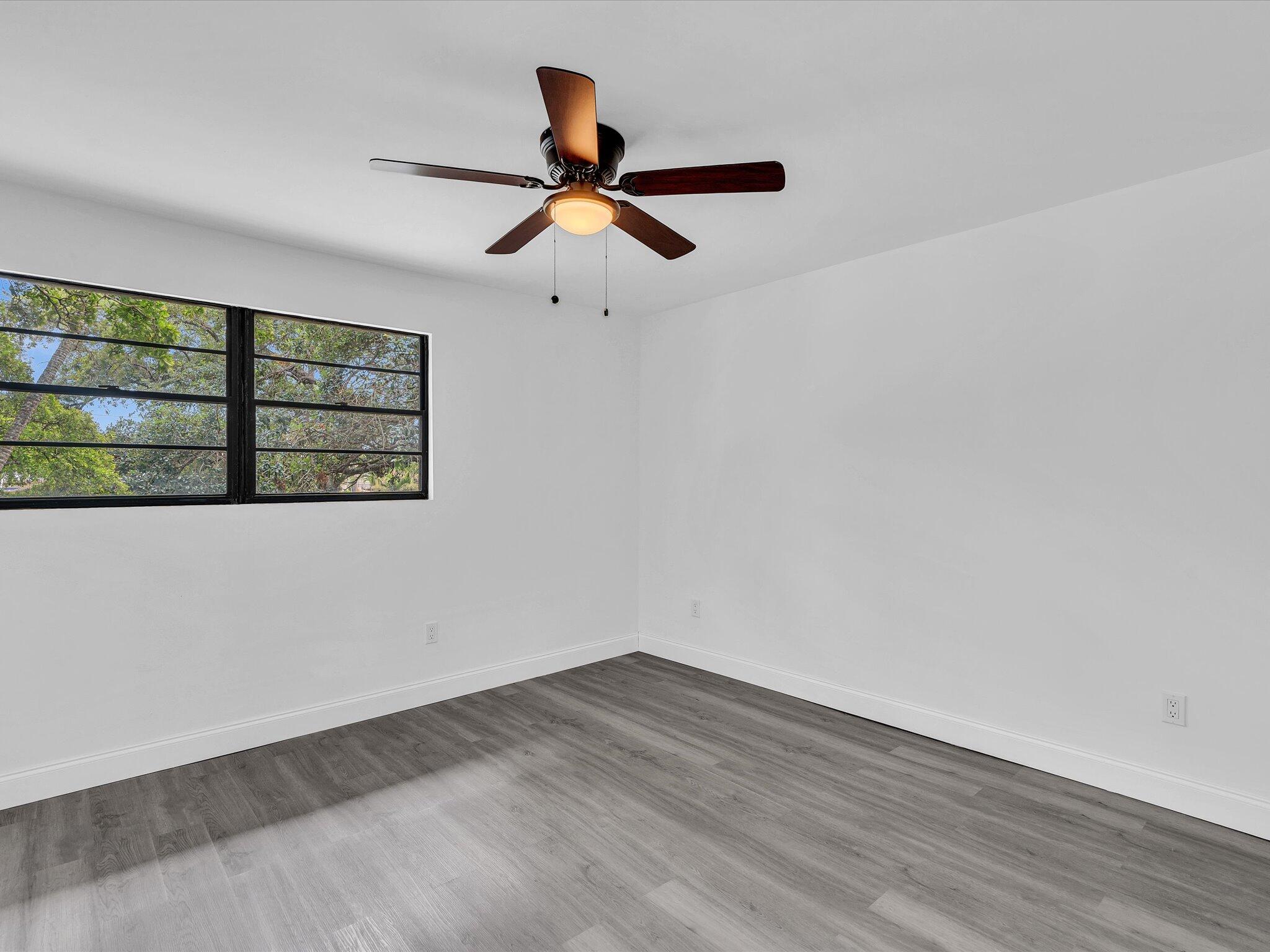 3841 Farragut Street Hollywood, FL 33021 - Photo 30 of 47 a view of empty room with wooden floor and fan