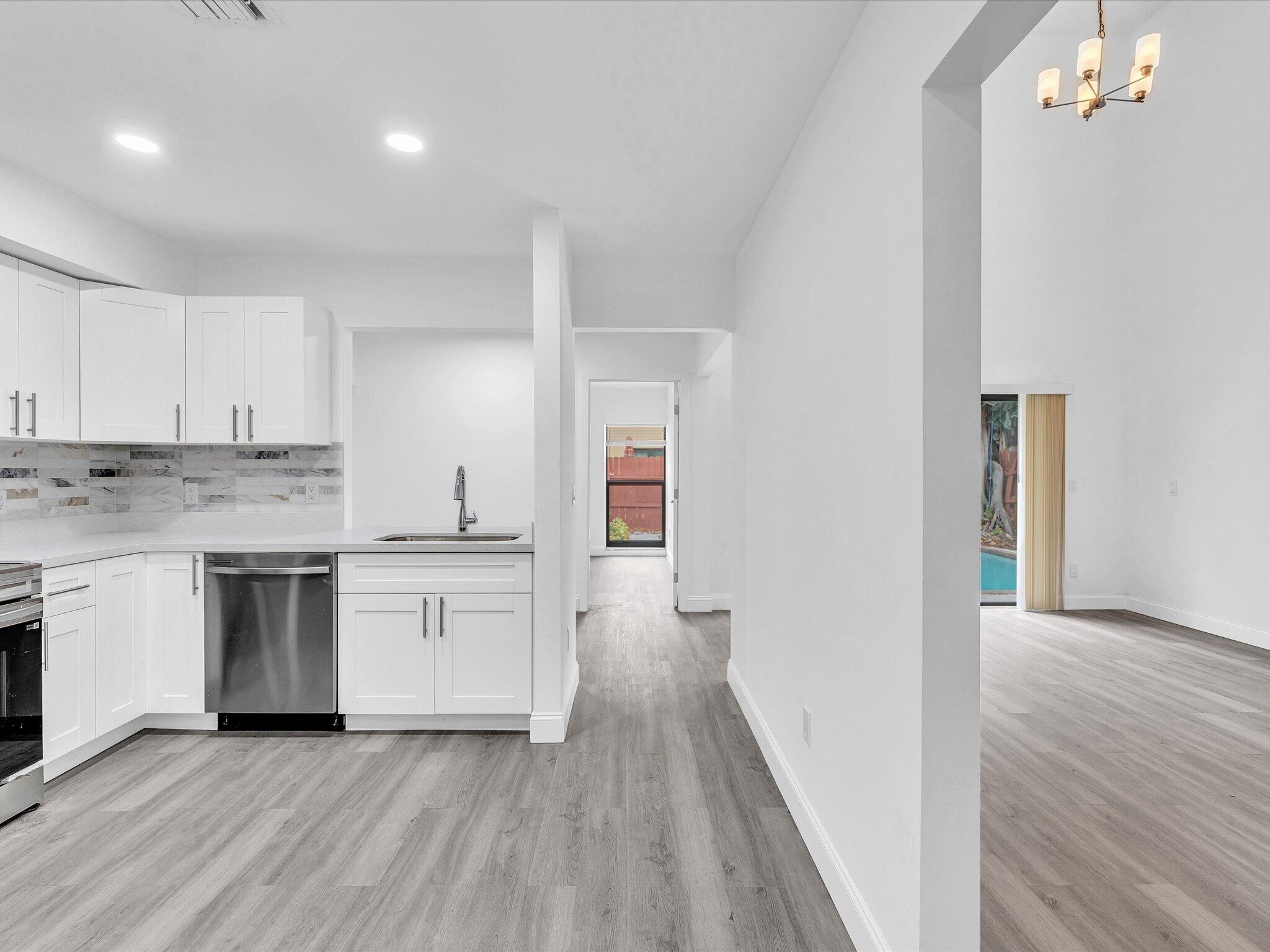 3841 Farragut Street Hollywood, FL 33021 - Photo 36 of 47 a kitchen with a white stove top oven and sink