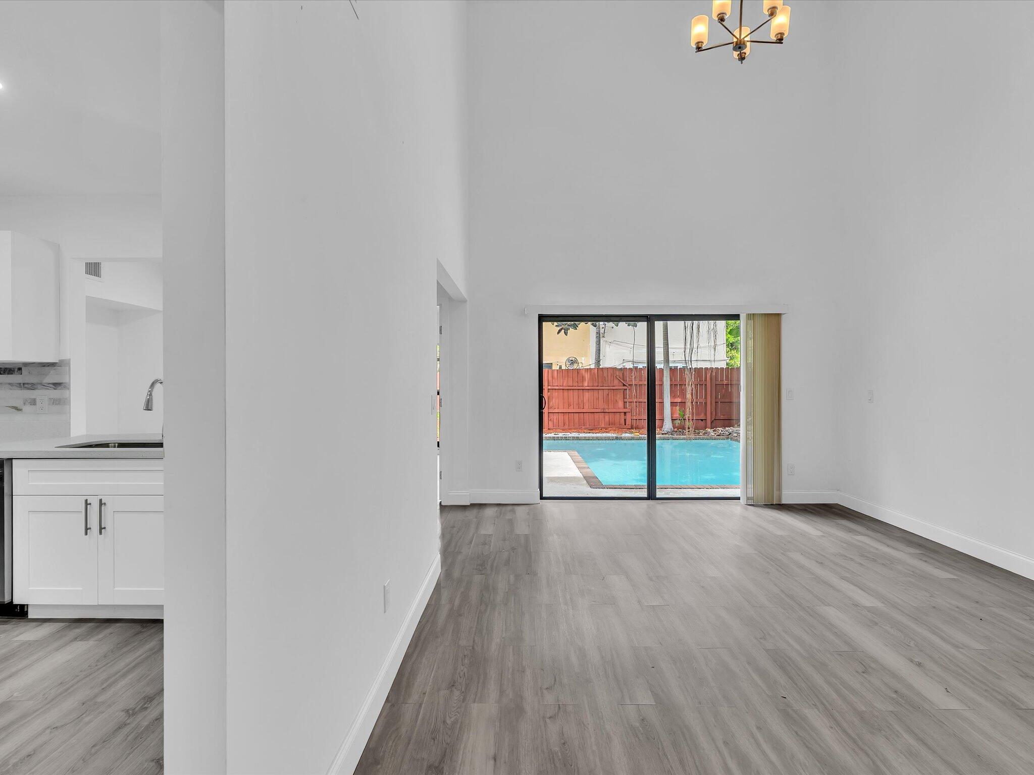 3841 Farragut Street Hollywood, FL 33021 - Photo 43 of 47 a view of an empty room with a window and wooden floor