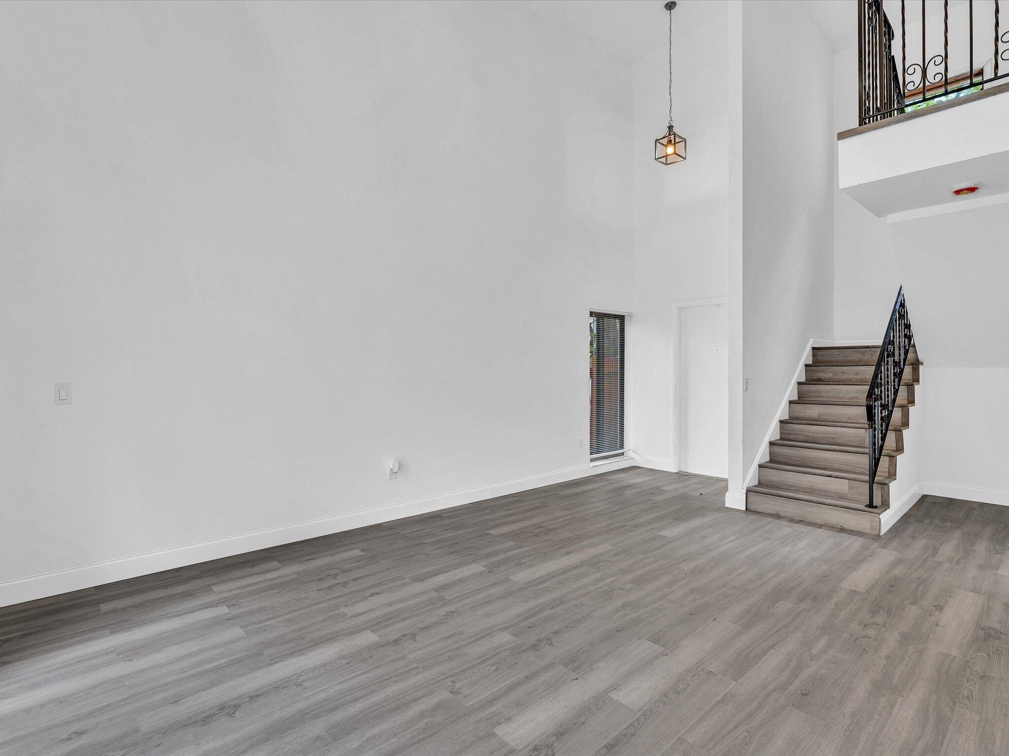 3841 Farragut Street Hollywood, FL 33021 - Photo 45 of 47 a view of an empty room with wooden floor and stairs