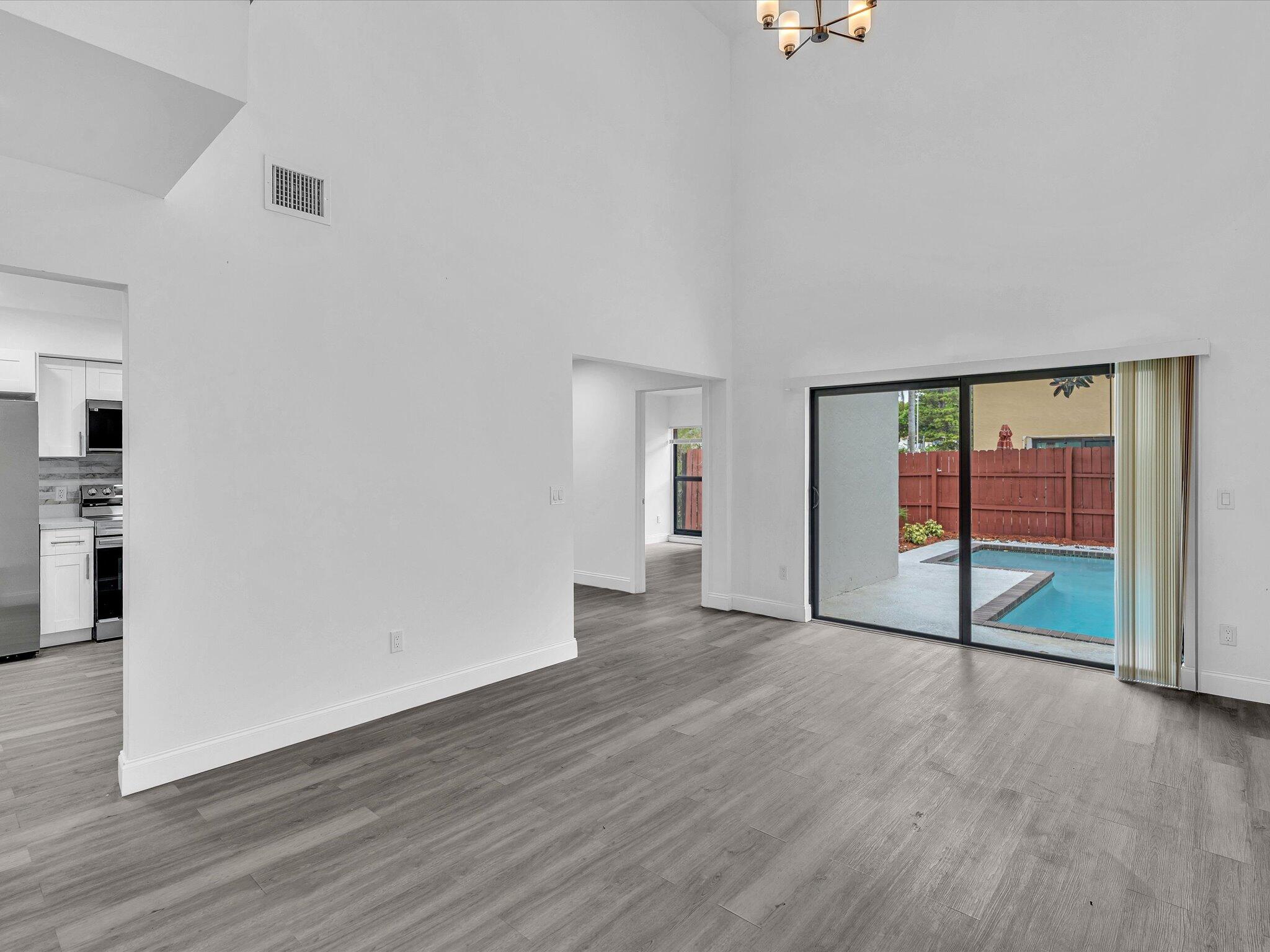 3841 Farragut Street Hollywood, FL 33021 - Photo 5 of 47 a view of an empty room with wooden floor and a window