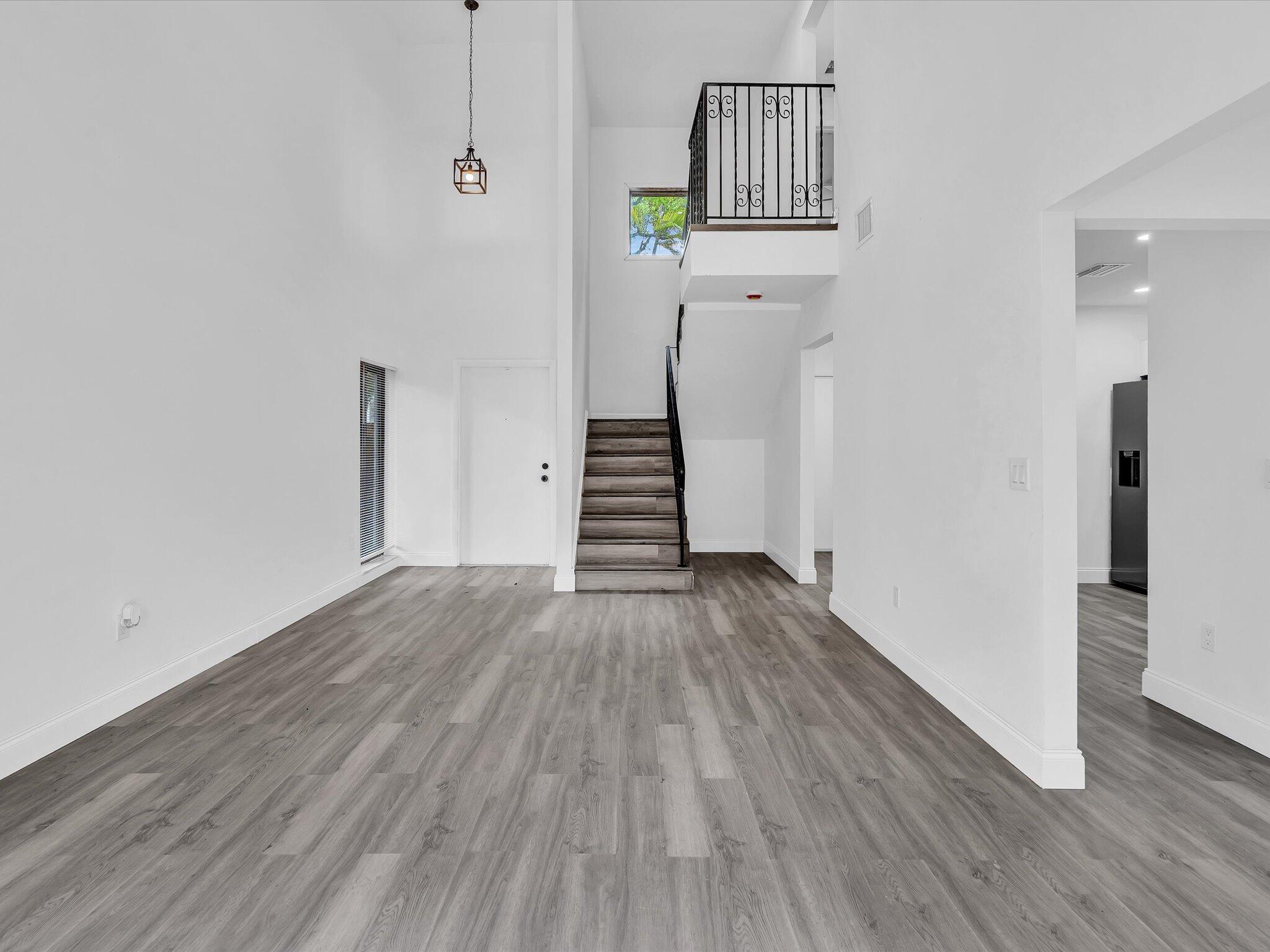 3841 Farragut Street Hollywood, FL 33021 - Photo 6 of 47 a view of a hallway with wooden floor and staircase