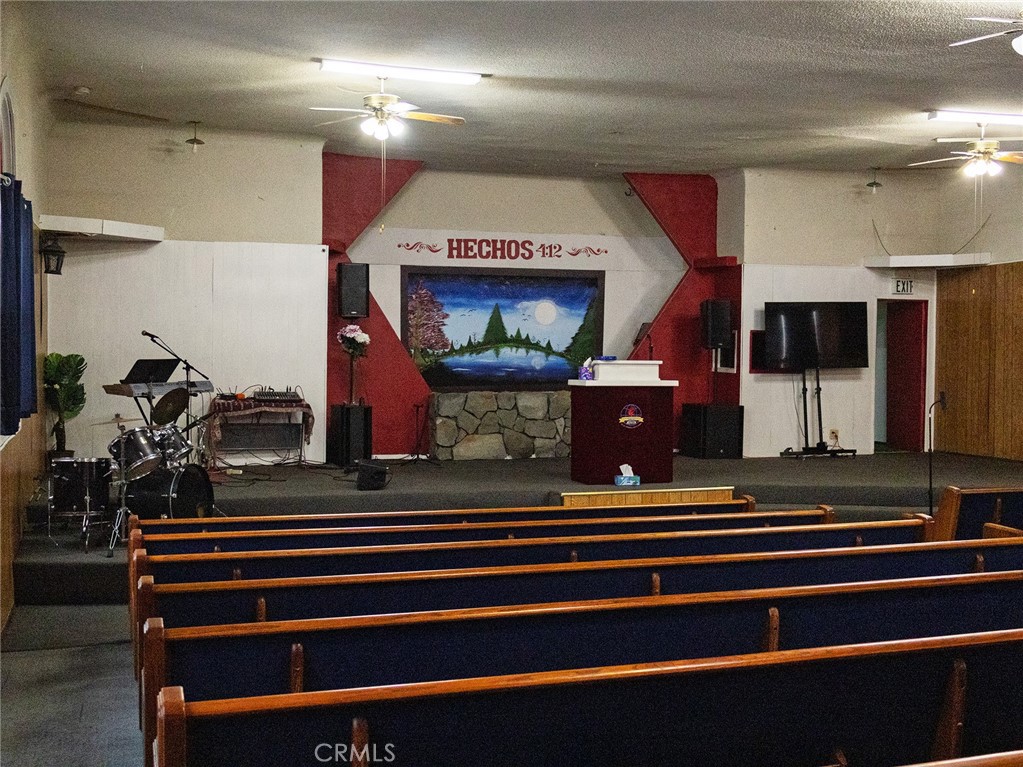 203 West 20th Street Merced, CA 95340 - Photo 3 of 10 a room with lots of white furniture and a chandelier