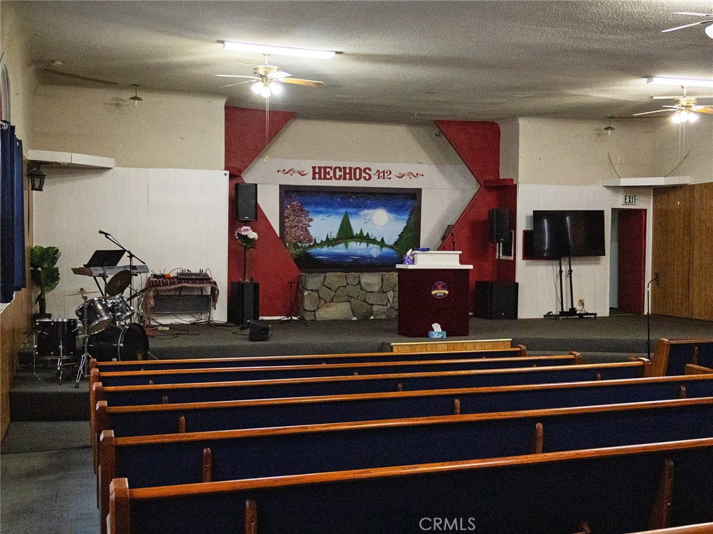 203 West 20th Street Merced, CA 95340 - Photo 4 of 10 a room with lots of white furniture and a chandelier