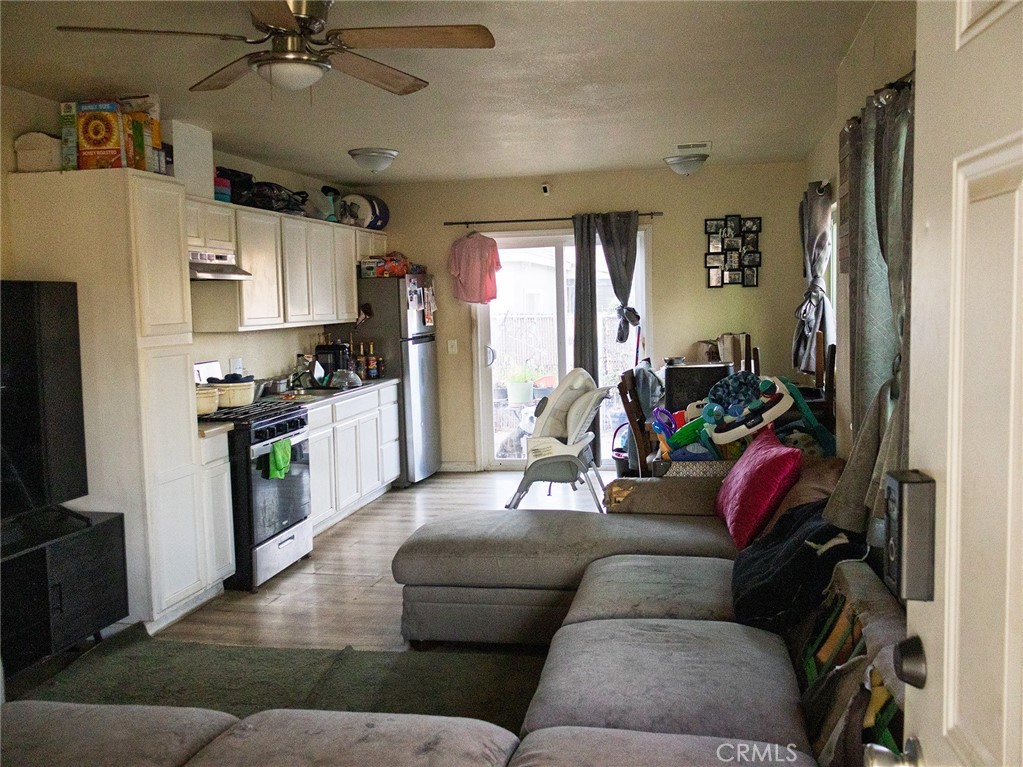 203 West 20th Street Merced, CA 95340 - Photo 8 of 10 a living room with furniture and a flat screen tv