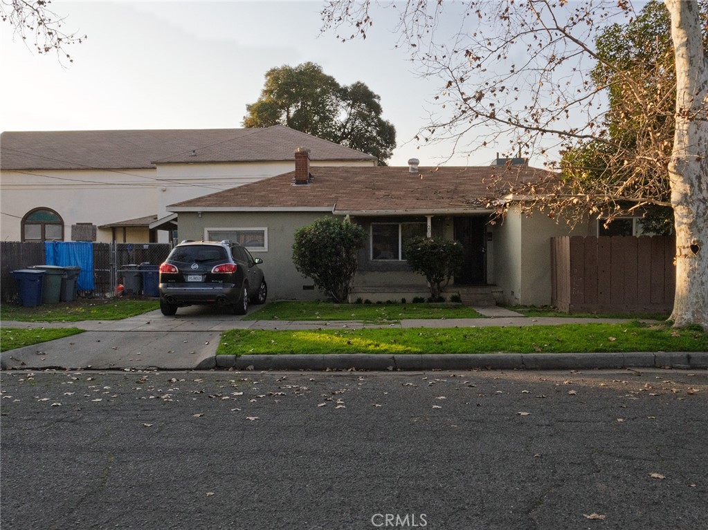 203 West 20th Street Merced, CA 95340 - Photo 9 of 10 a front view of a house with a garden and parking