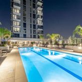 a view of a swimming pool with outdoor seating