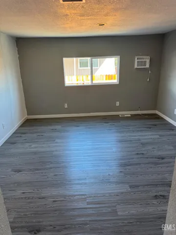 a view of wooden floor and windows in a room
