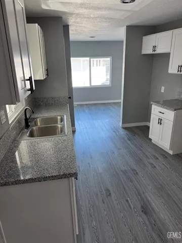 a kitchen with sink and mirror