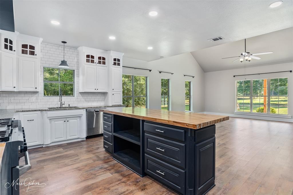 550 Linton Bellevue Road Benton, LA 71006 - Photo 13 of 37 Kitchen with butcher block island, granite counters, dark cabinets, tasteful backsplash, a kitchen island, and white cabinets