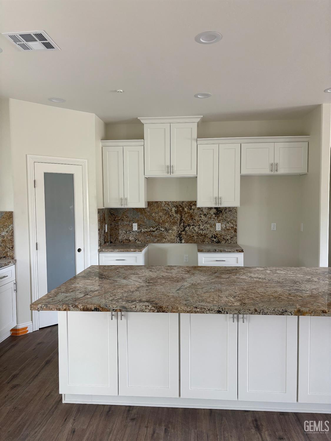 a kitchen with granite countertop white cabinets granite counter tops and a sink