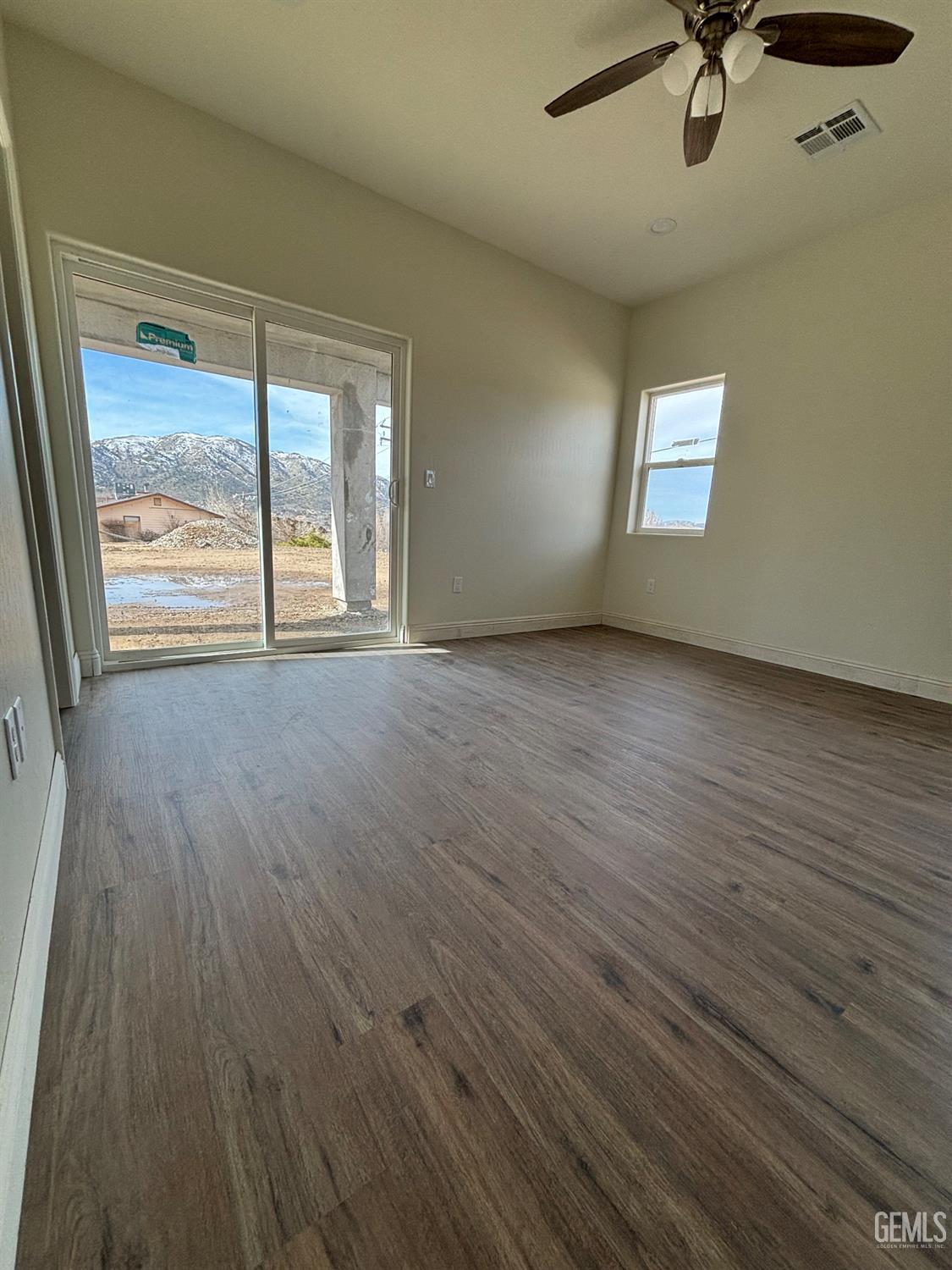 Undisclosed Address Tehachapi, CA 93561 - Photo 11 of 14 a view of an empty room with a window and wooden floor