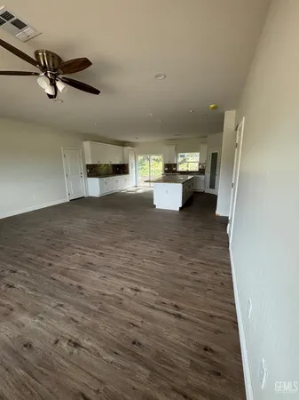 a view of a livingroom with a stove and cabinets