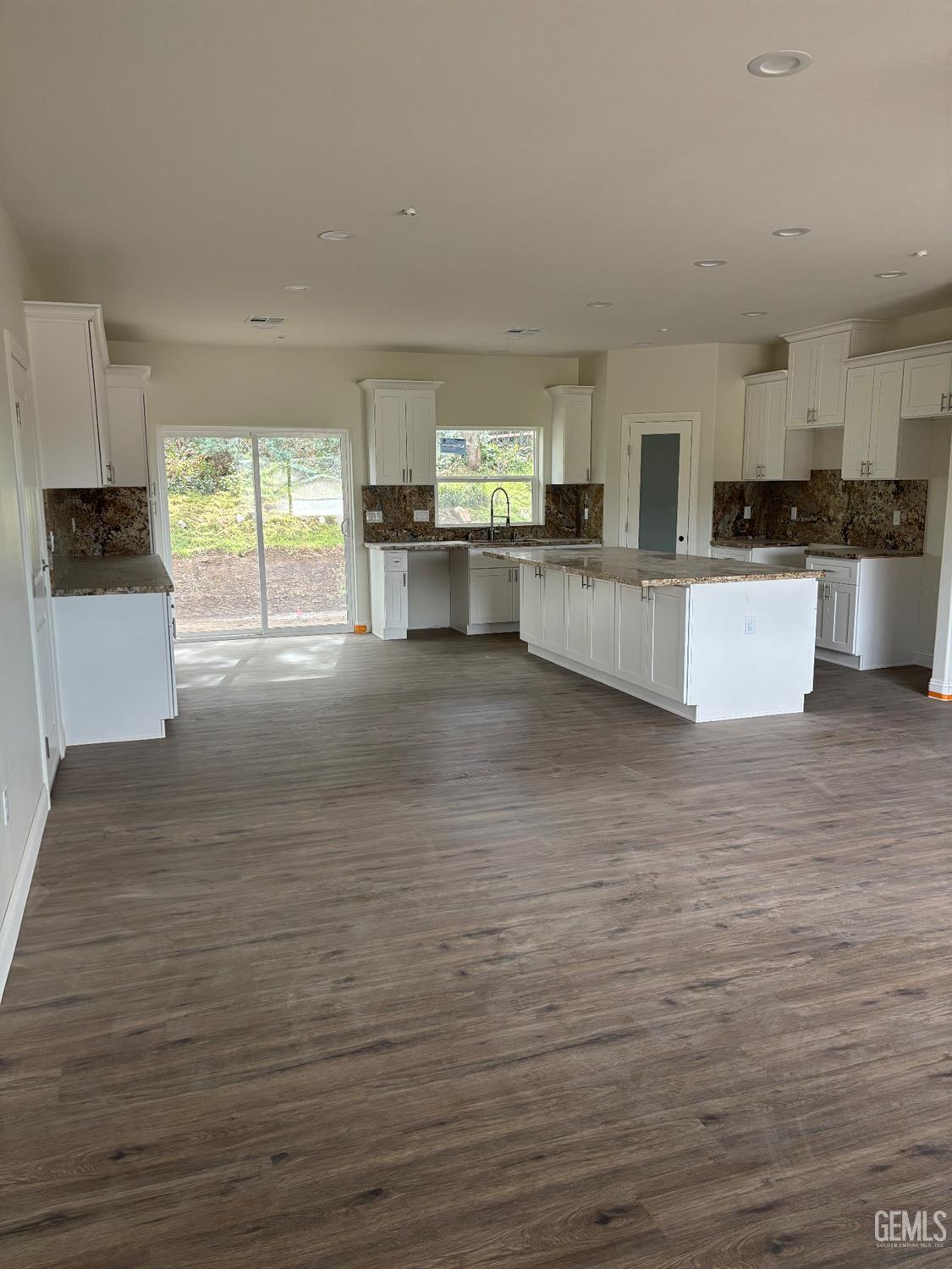 Undisclosed Address Tehachapi, CA 93561 - Photo 5 of 14 a large kitchen with stainless steel appliances kitchen island granite countertop a stove a sink and a refrigerator