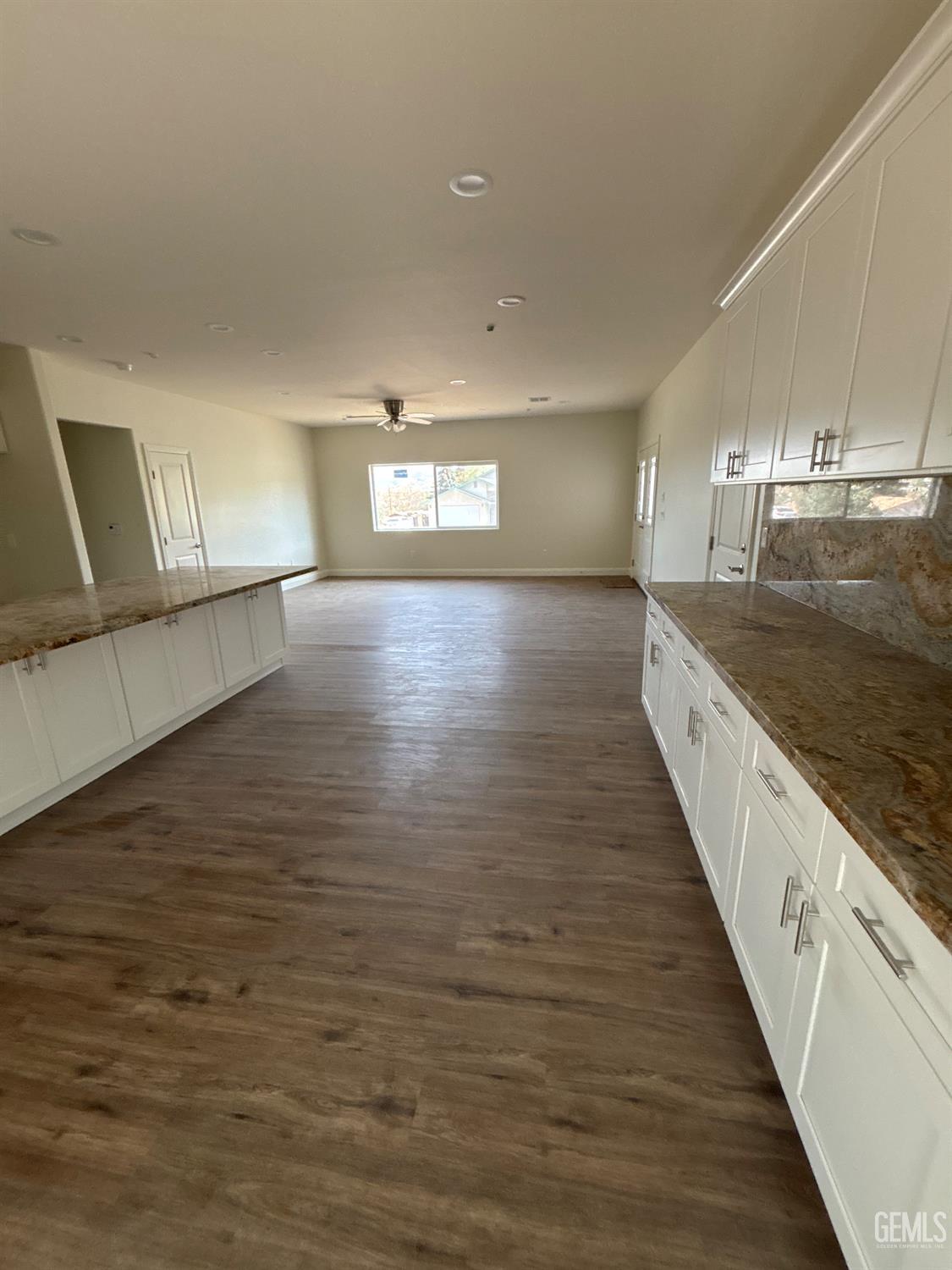Undisclosed Address Tehachapi, CA 93561 - Photo 10 of 24 a view of a kitchen with kitchen island a sink wooden floor and black appliances