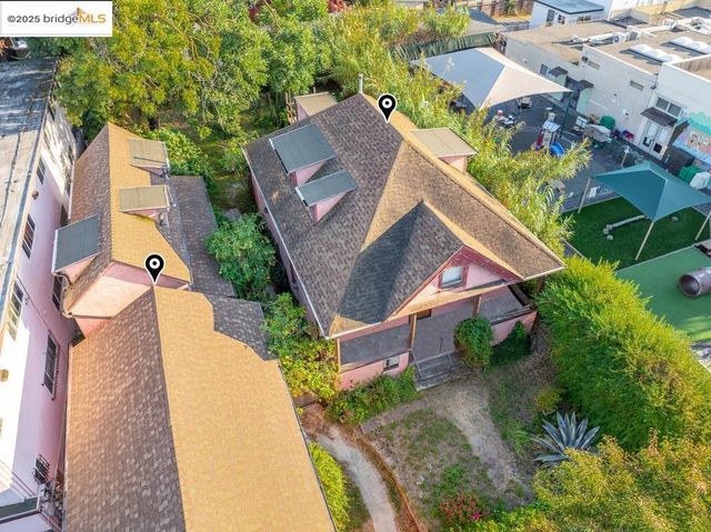 an aerial view of a house with a garden and trees