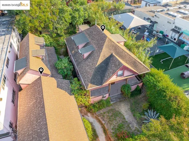 an aerial view of a house with a garden and trees