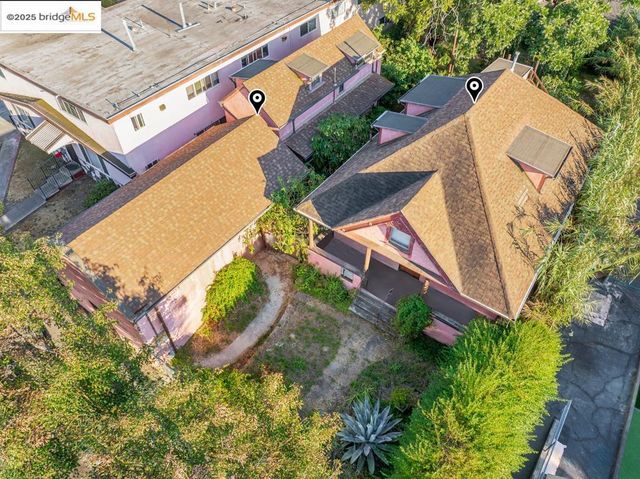 an aerial view of a house with a yard and outdoor seating