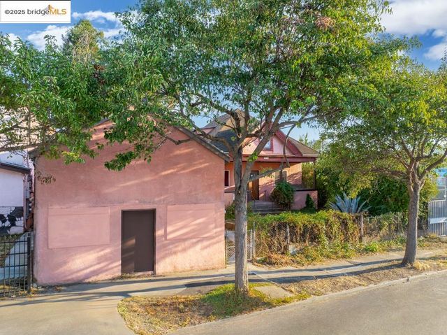 a view of a house with a tree in front