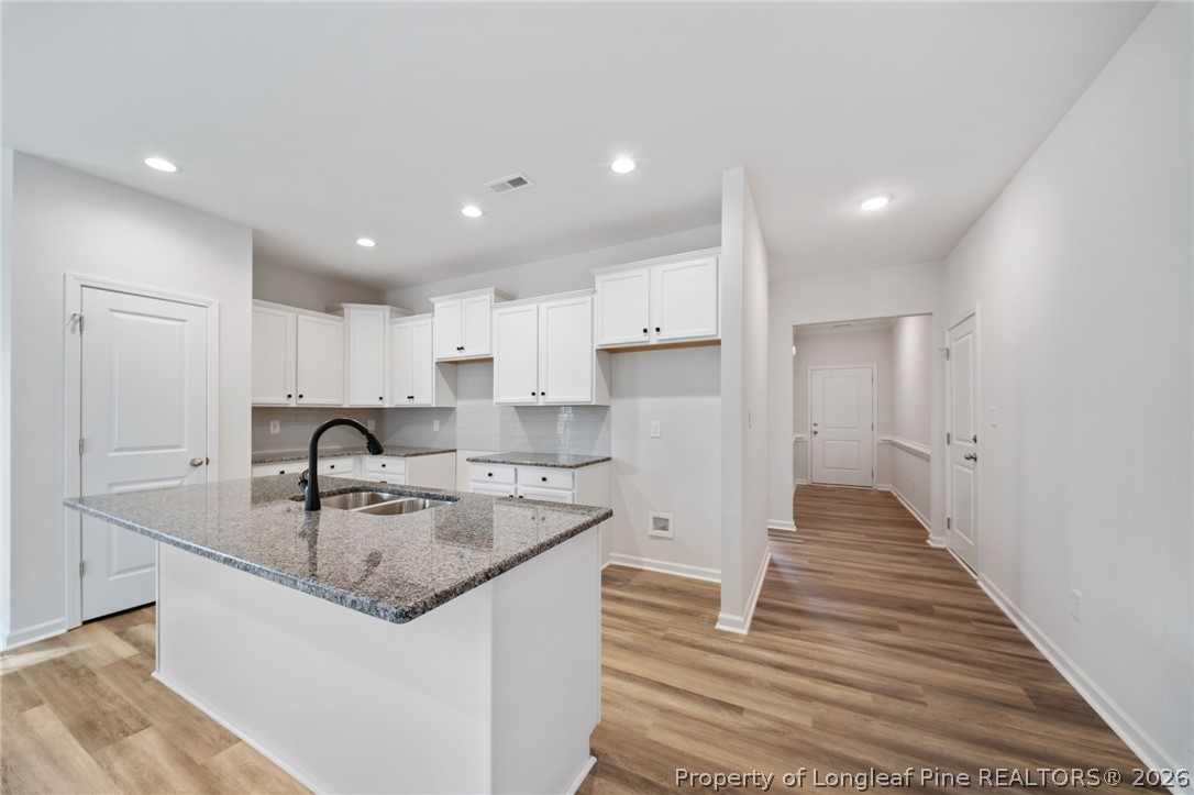 4052 Lofton Street Wade, NC 28395 - Photo 6 of 22 a kitchen with kitchen island granite countertop a sink and a refrigerator