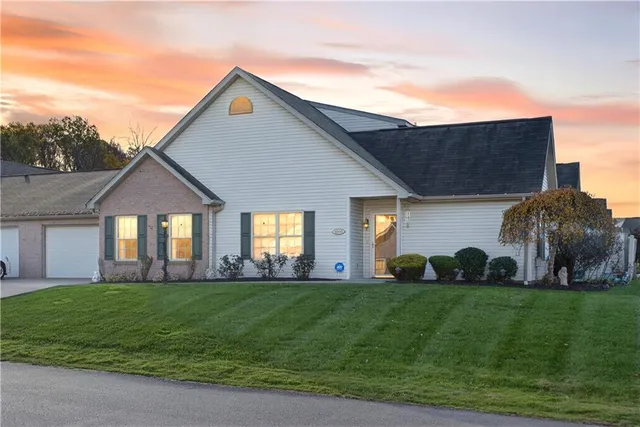 a front view of house with a garden