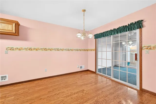 a view of a room with wooden floor and windows