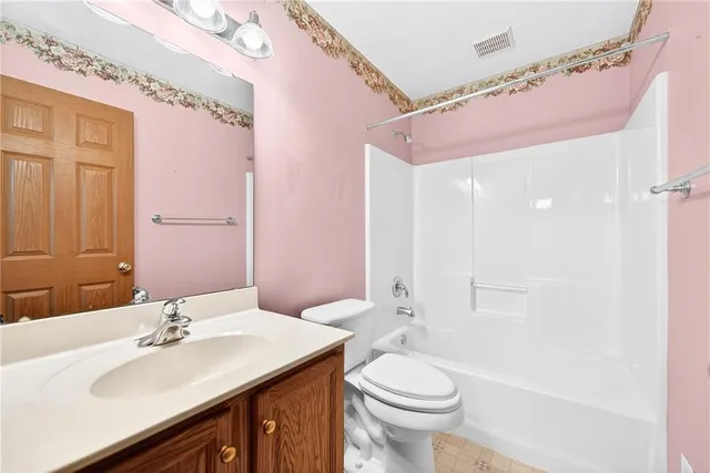 an empty room with a fan & a window