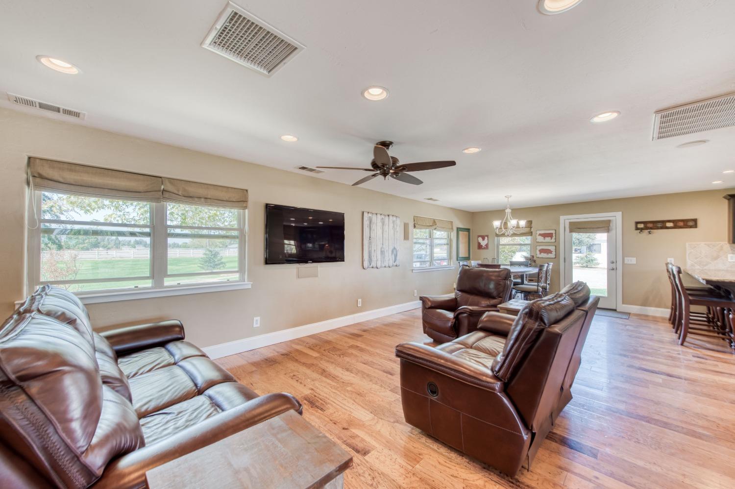 5588 North McCall Avenue Clovis, CA 93619 - Photo 11 of 77 a living room with furniture and a flat screen tv with wooden floor