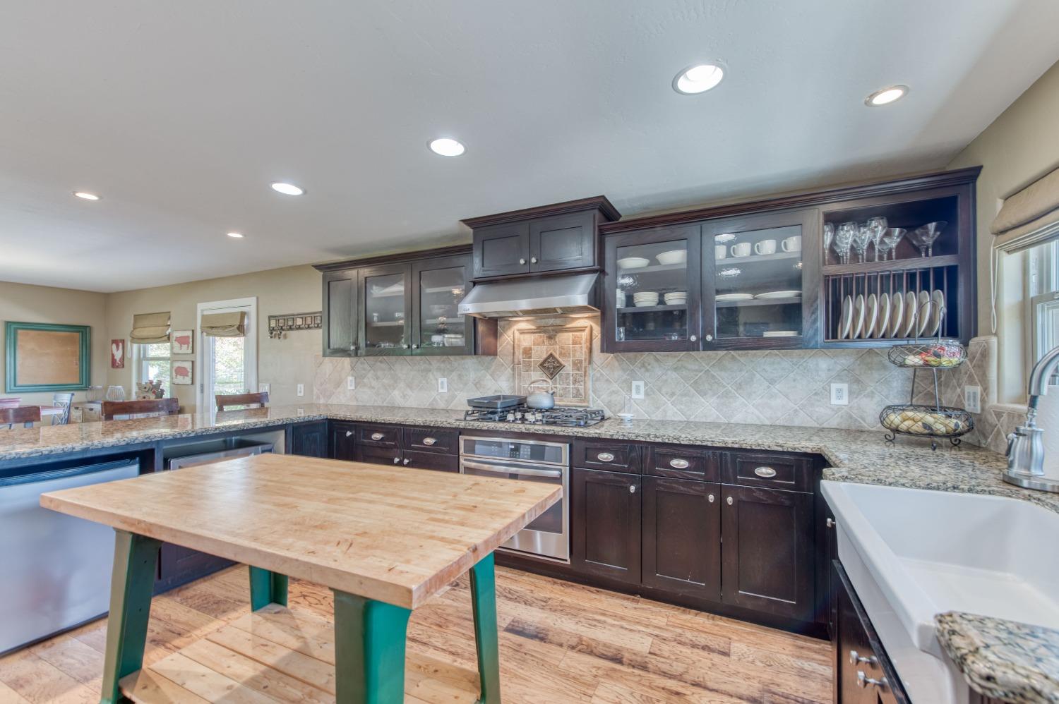 5588 North McCall Avenue Clovis, CA 93619 - Photo 19 of 77 a kitchen with a table chairs sink and cabinets