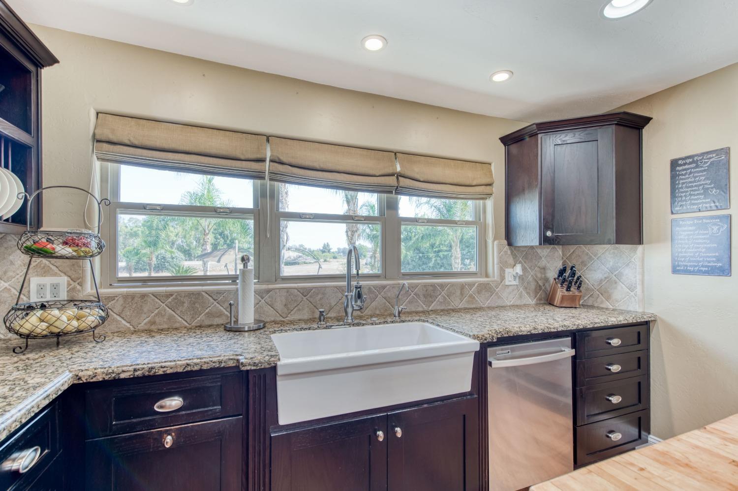 5588 North McCall Avenue Clovis, CA 93619 - Photo 22 of 77 a kitchen with a sink a window and cabinets