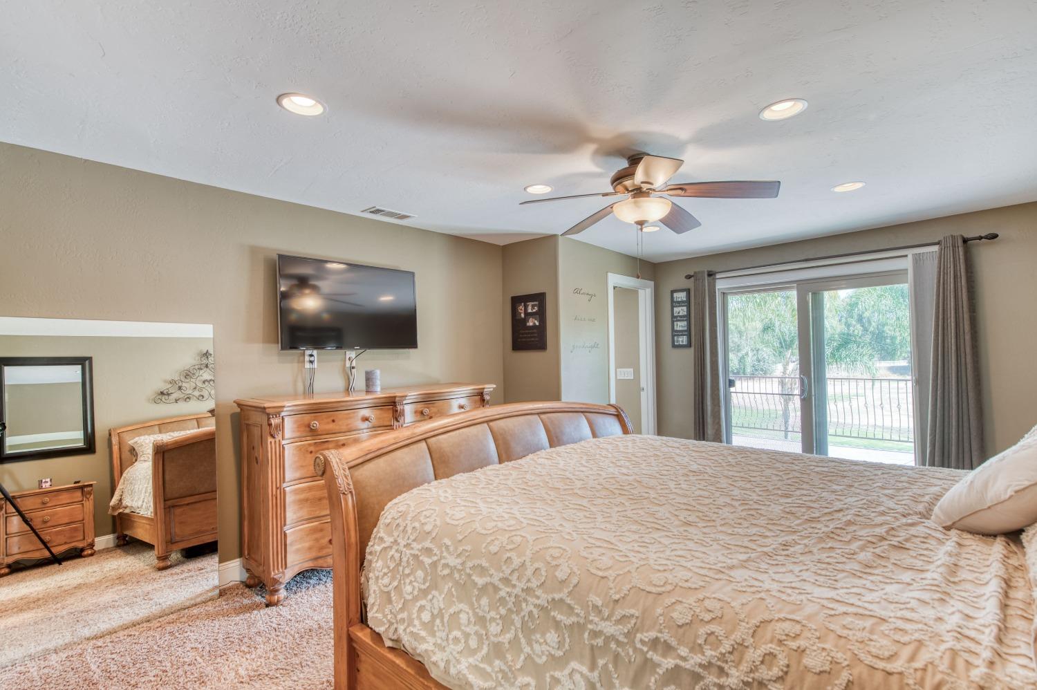 5588 North McCall Avenue Clovis, CA 93619 - Photo 31 of 77 a bedroom with a bed and a flat screen tv