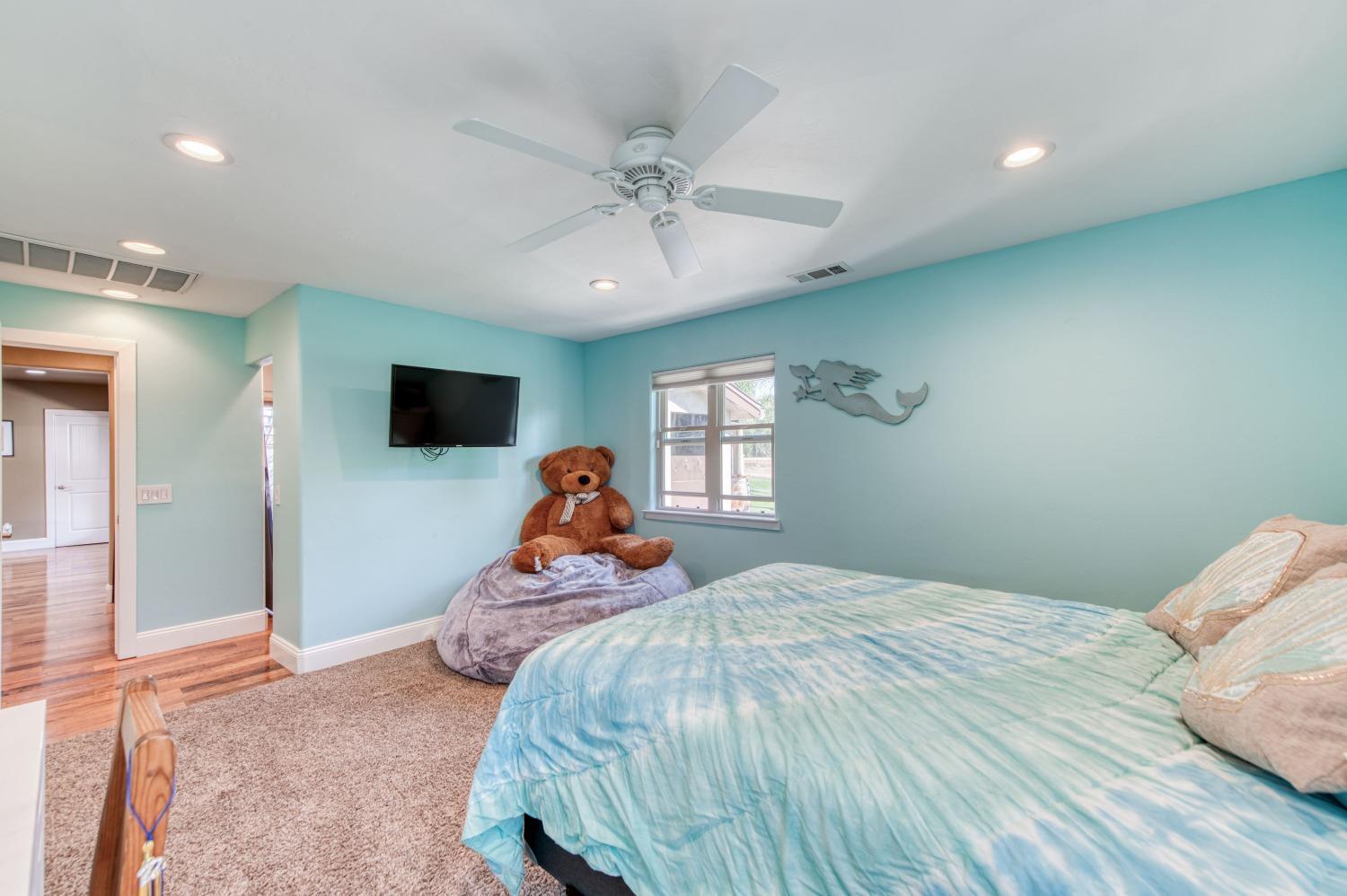 5588 North McCall Avenue Clovis, CA 93619 - Photo 44 of 77 a bed room with a bed and a tv