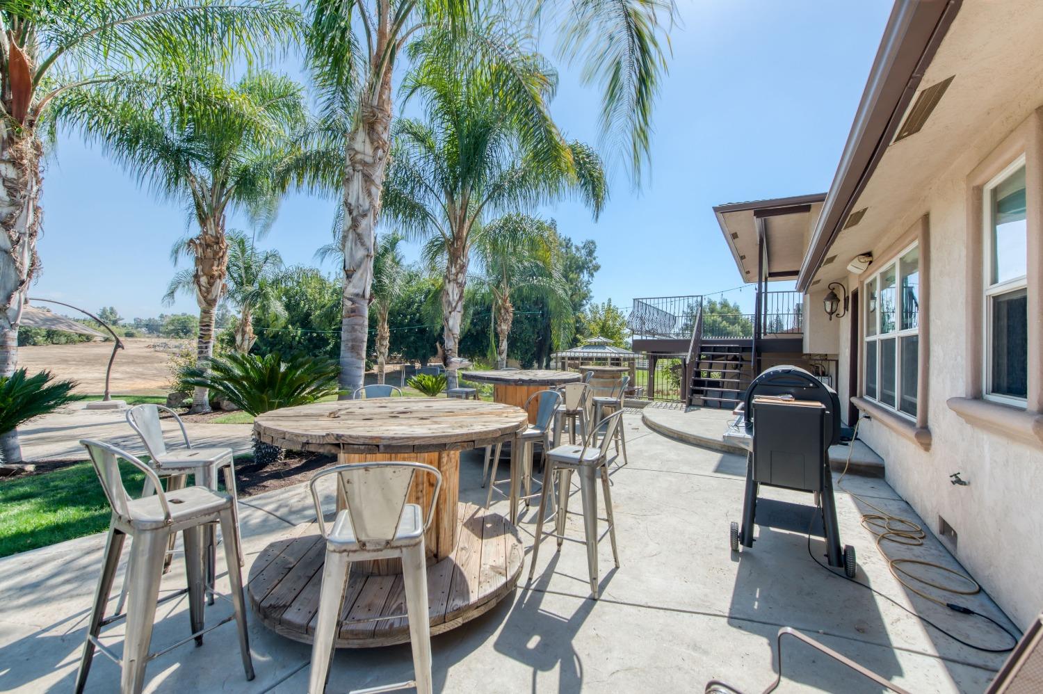 5588 North McCall Avenue Clovis, CA 93619 - Photo 48 of 77 a view of outdoor dining space with a table and chairs