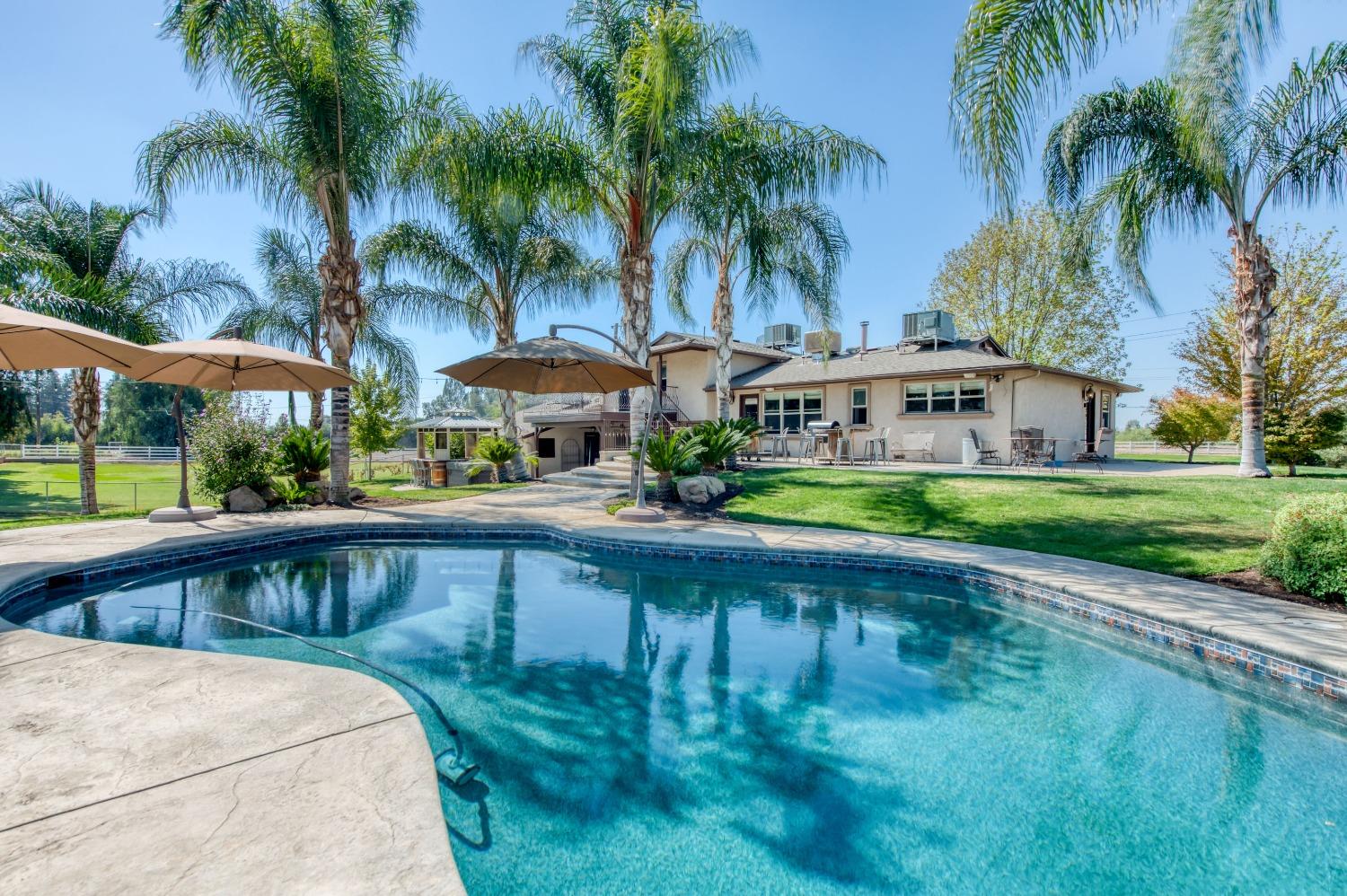 5588 North McCall Avenue Clovis, CA 93619 - Photo 55 of 77 a swimming pool with outdoor seating and yard