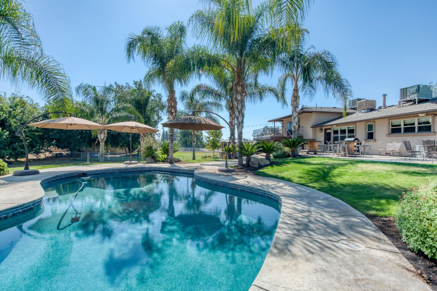 5588 North McCall Avenue Clovis, CA 93619 - Photo 56 of 77 a swimming pool with outdoor seating and yard