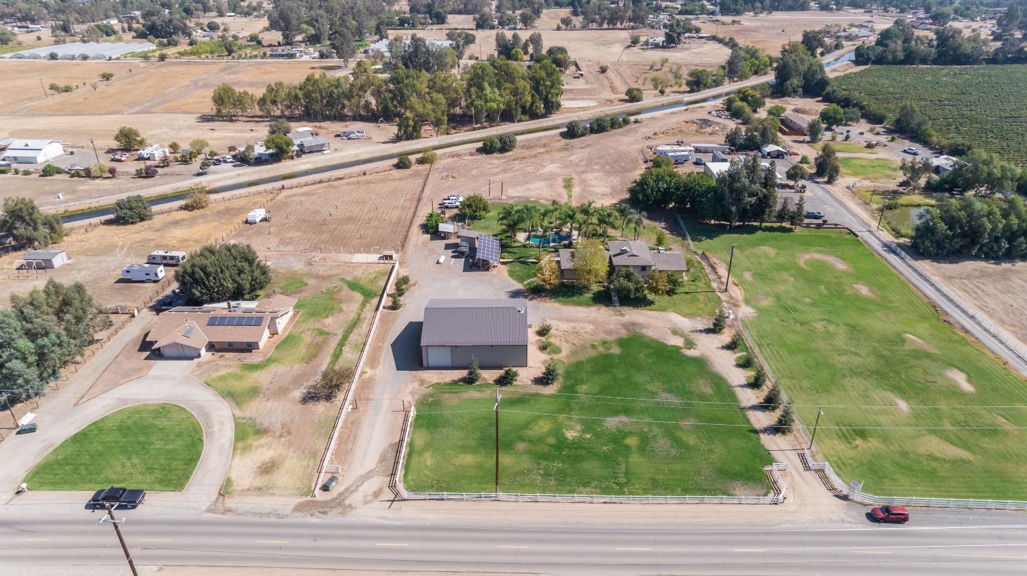 5588 North McCall Avenue Clovis, CA 93619 - Photo 61 of 77 an aerial view of a house with a yard and lake view