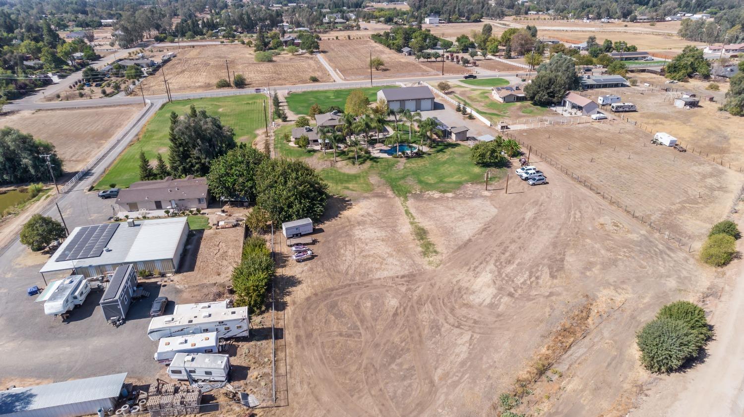 5588 North McCall Avenue Clovis, CA 93619 - Photo 67 of 77 an aerial view of a house with a yard and lake view