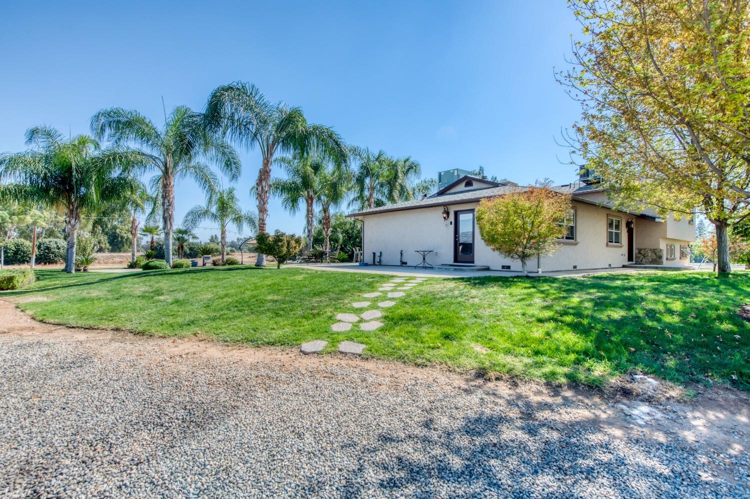 5588 North McCall Avenue Clovis, CA 93619 - Photo 7 of 77 a front view of house with yard and green space