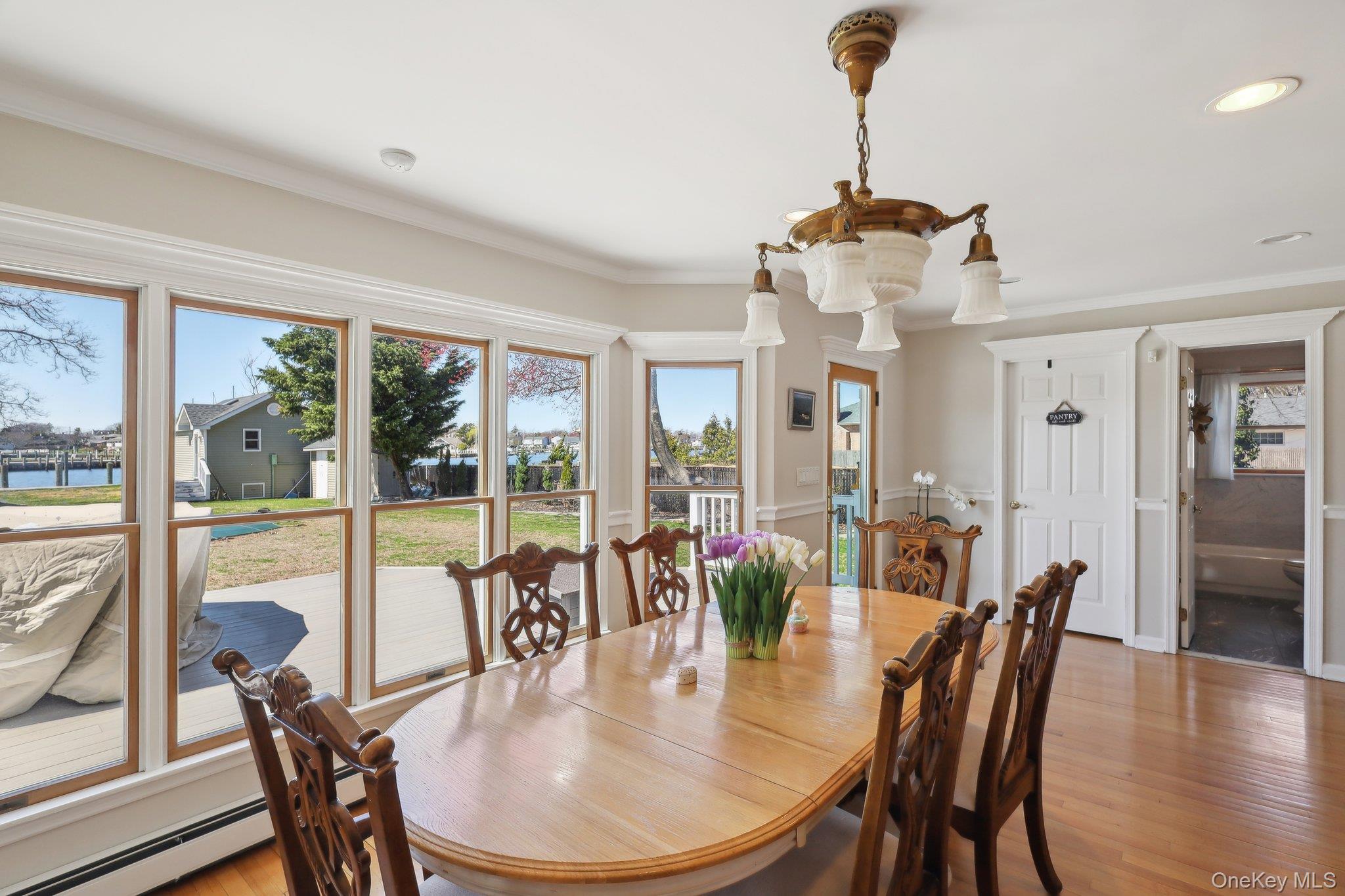 230 West Islip Road West Islip, NY 11795 - Photo 14 of 50 Dining area with crown molding, recessed lighting, a baseboard heating unit, and light wood-style floors