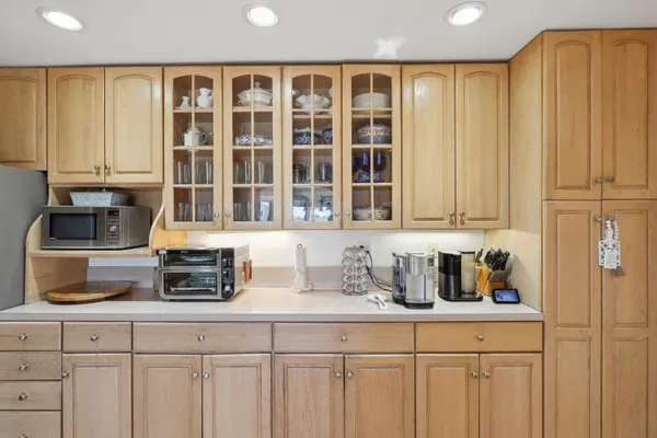 a kitchen with stainless steel appliances granite countertop a refrigerator and cabinets