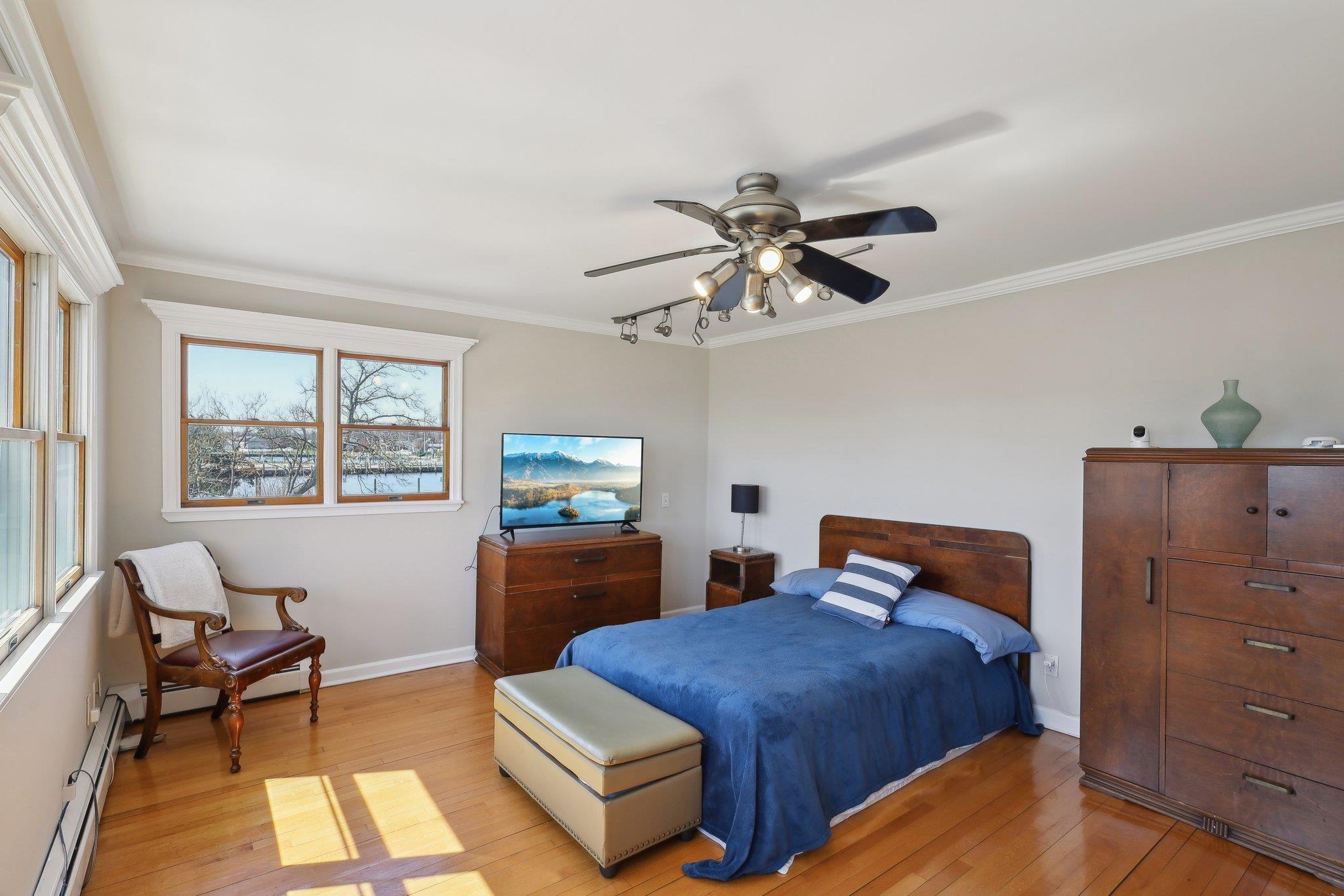 230 West Islip Road West Islip, NY 11795 - Photo 21 of 49 a bedroom with a bed and a chandelier