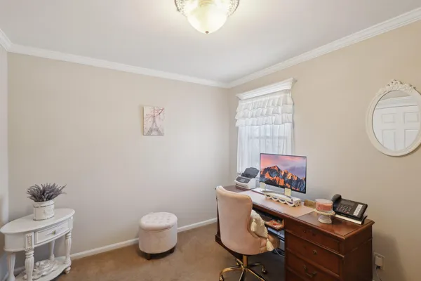 a view of a workspace with furniture and a window