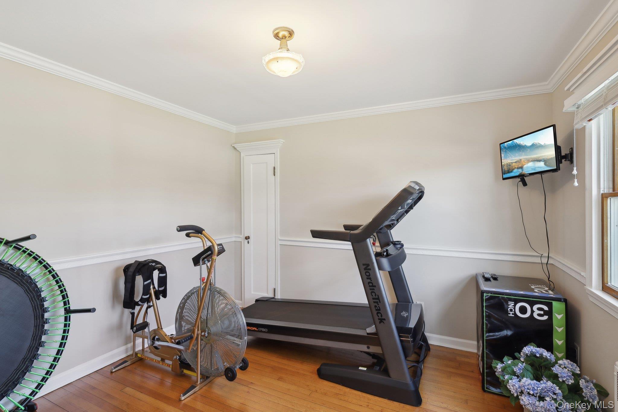 230 West Islip Road West Islip, NY 11795 - Photo 27 of 50 Exercise room with hardwood / wood-style floors, crown molding, and baseboards