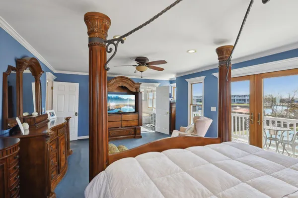 a bedroom with furniture and large windows