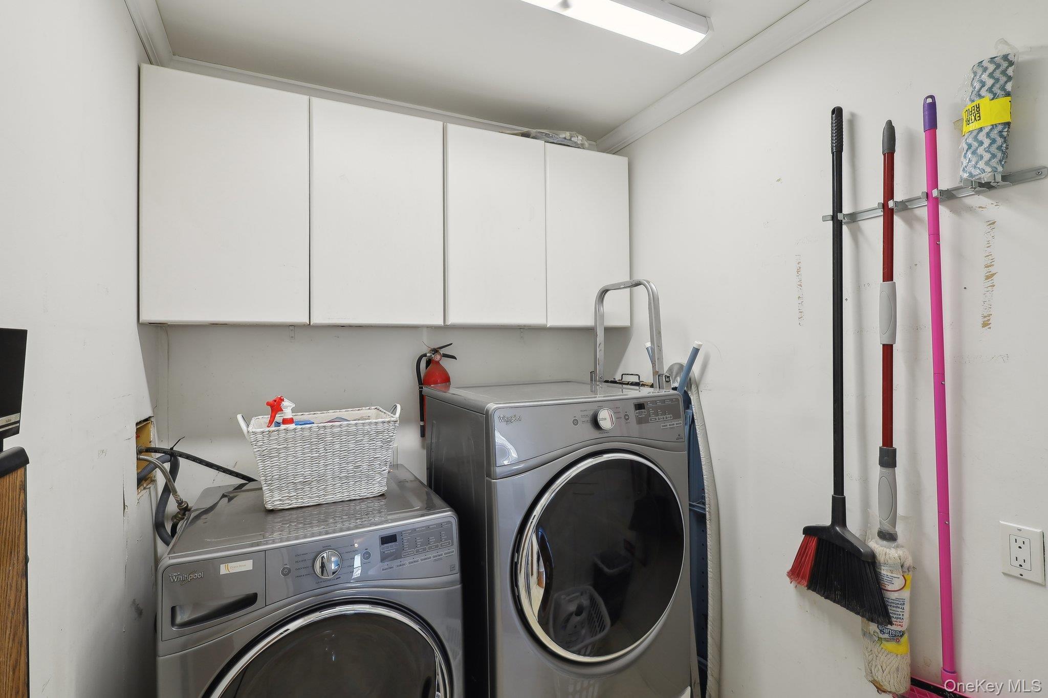 230 West Islip Road West Islip, NY 11795 - Photo 33 of 50 Laundry room featuring independent washer and dryer and cabinet space